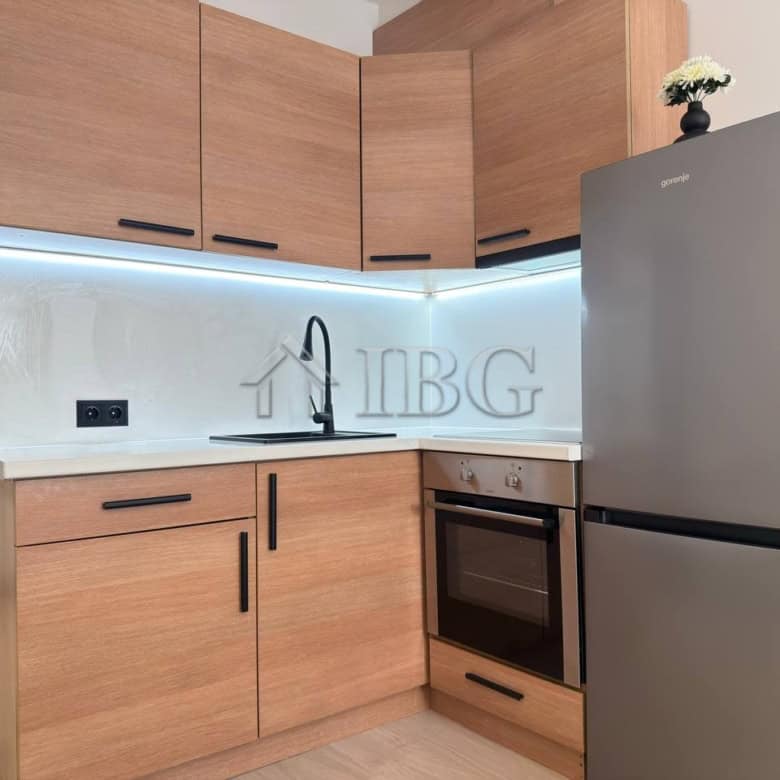 Modern kitchen with wooden cabinets and stainless steel appliances in Panorama Bay 2, Sveti Vlas.