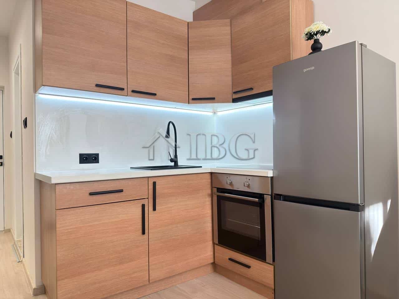 Modern kitchen with wooden cabinets and stainless steel appliances in Panorama Bay 2, Sveti Vlas.