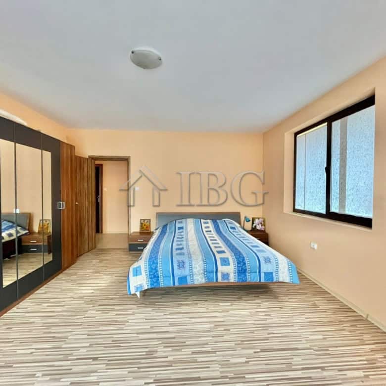 Spacious bedroom with large window and built-in wardrobe in Goritsa Village home.