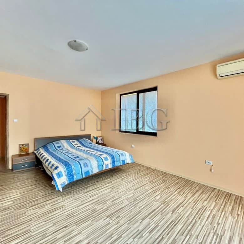 Spacious bedroom with large window and air conditioning in Goritsa Village property.
