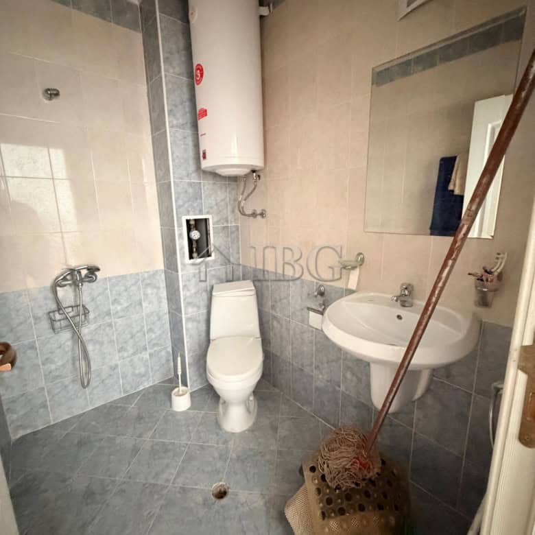 Compact bathroom with toilet, sink, and water heater in Sunny Day 5 area.