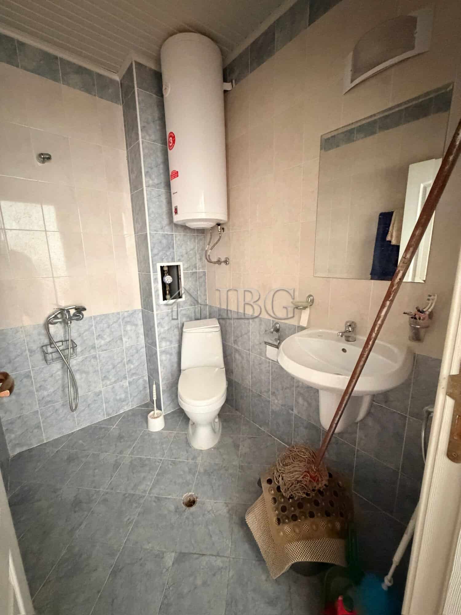 Compact bathroom with toilet, sink, and water heater in Sunny Day 5 area.