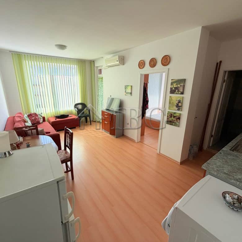 Bright living room with large windows and modern furnishings in Sunny Day 5, Sunny Beach.