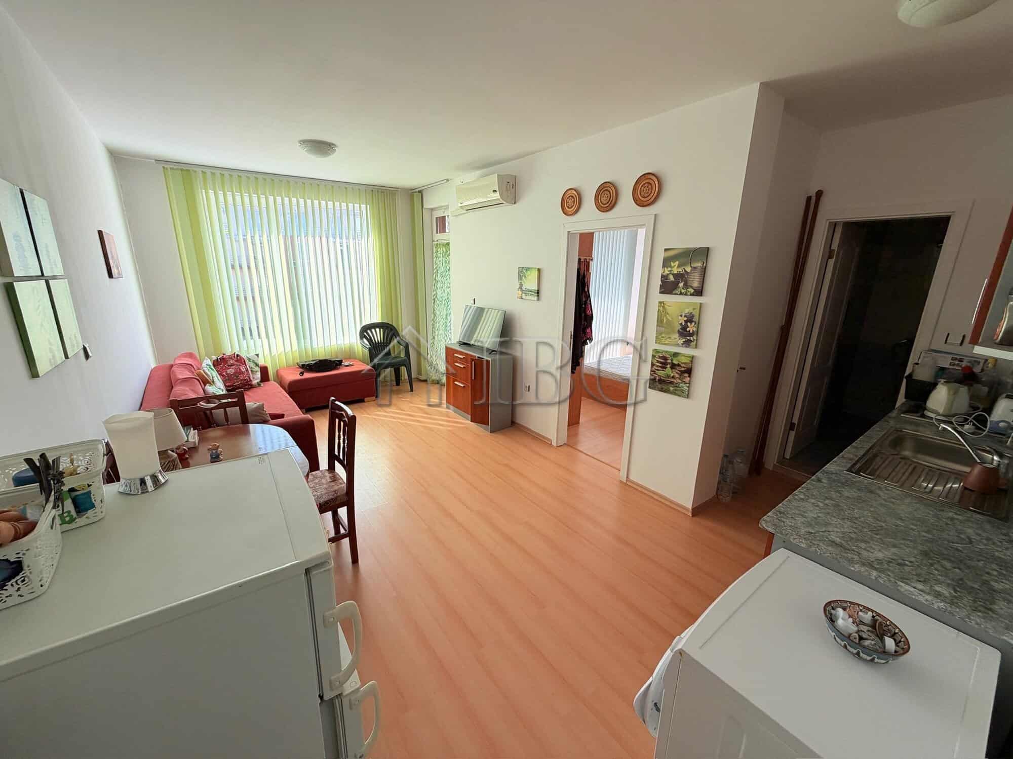Bright living room with large windows and modern furnishings in Sunny Day 5, Sunny Beach.