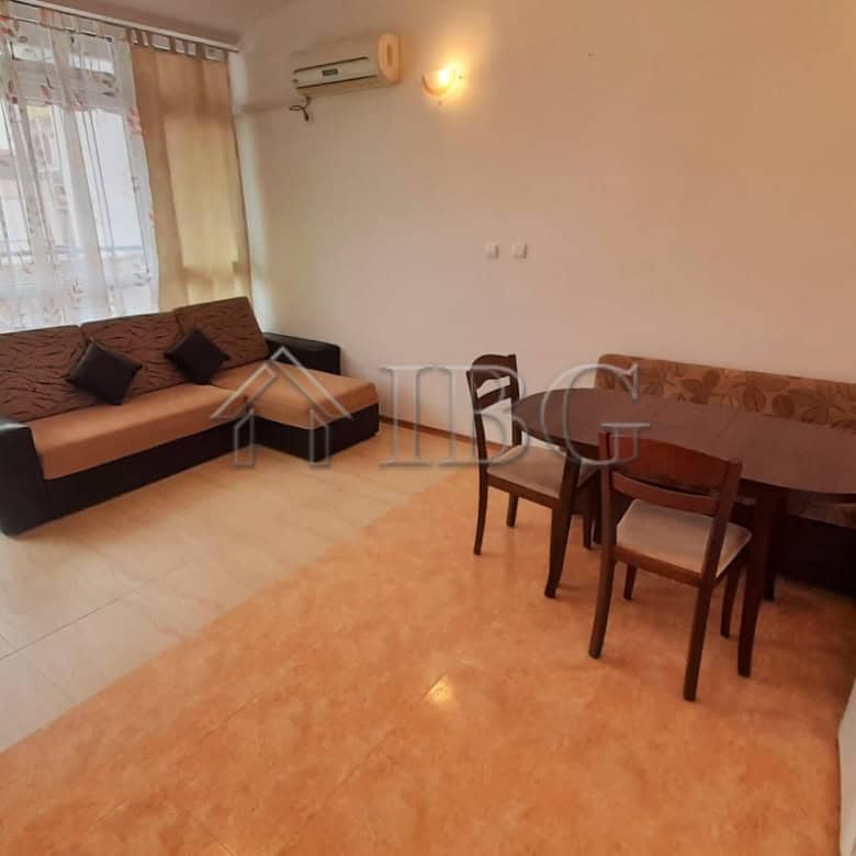 Bright 1-bedroom apartment with pool view, living area, dining space, and balcony in Sunny Beach.
