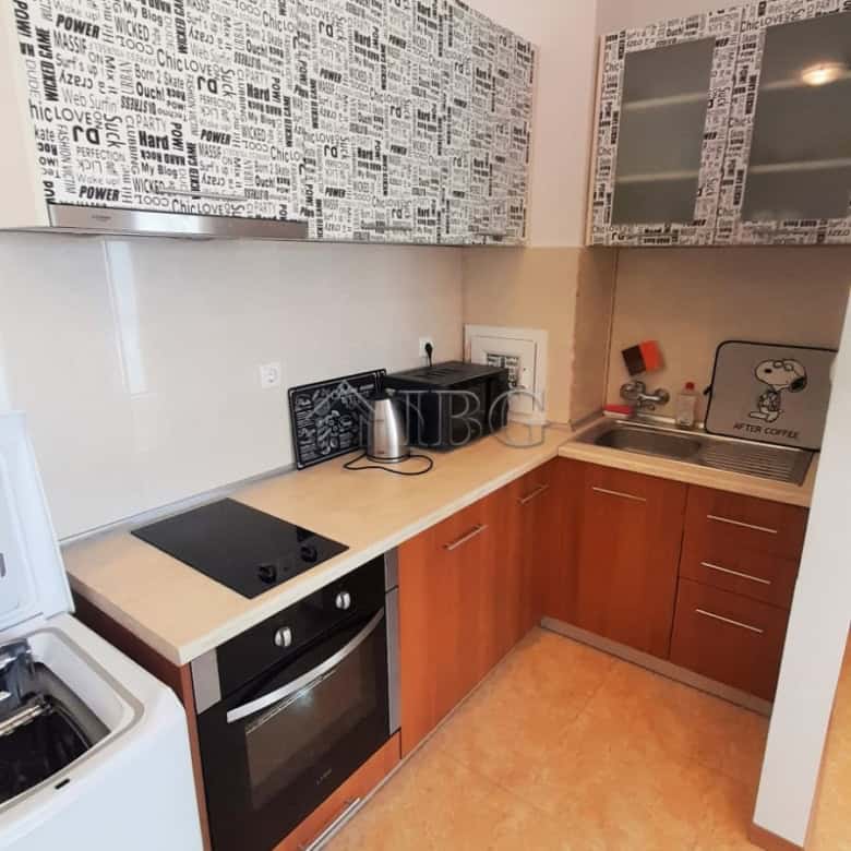 Cozy kitchen with modern appliances and stylish decor in a 1-bedroom apartment at Sunny Beach.