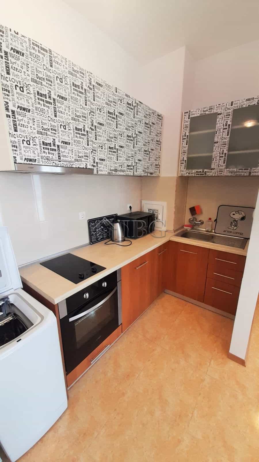 Cozy kitchen with modern appliances and stylish decor in a 1-bedroom apartment at Sunny Beach.