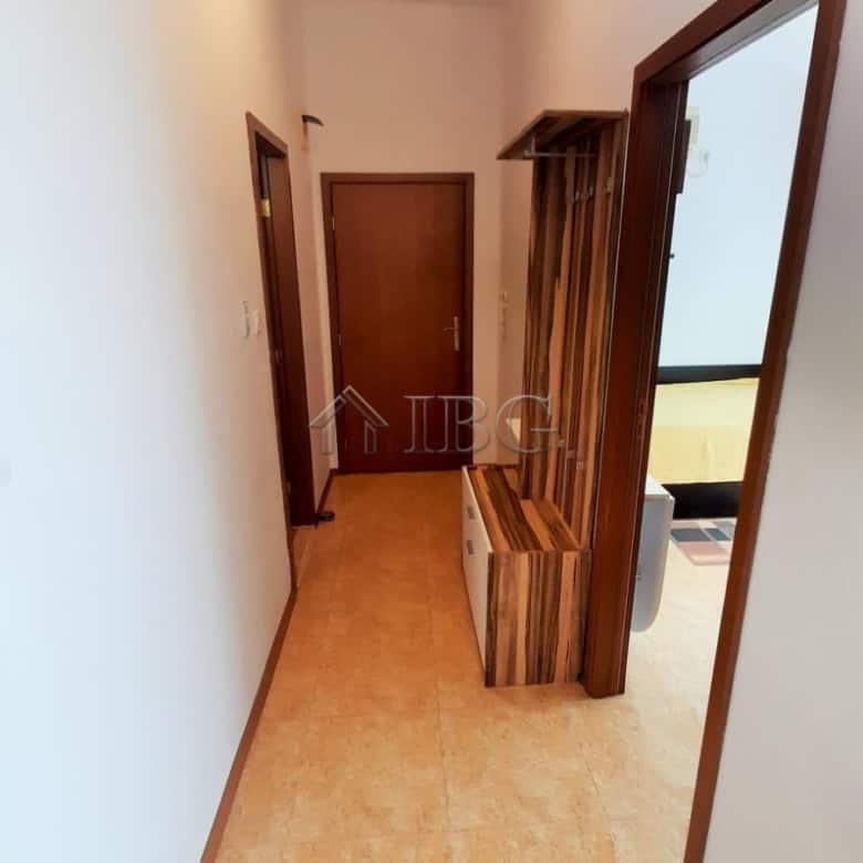 Bright hallway in a modern 1-bedroom apartment with wooden accents and a cozy atmosphere.