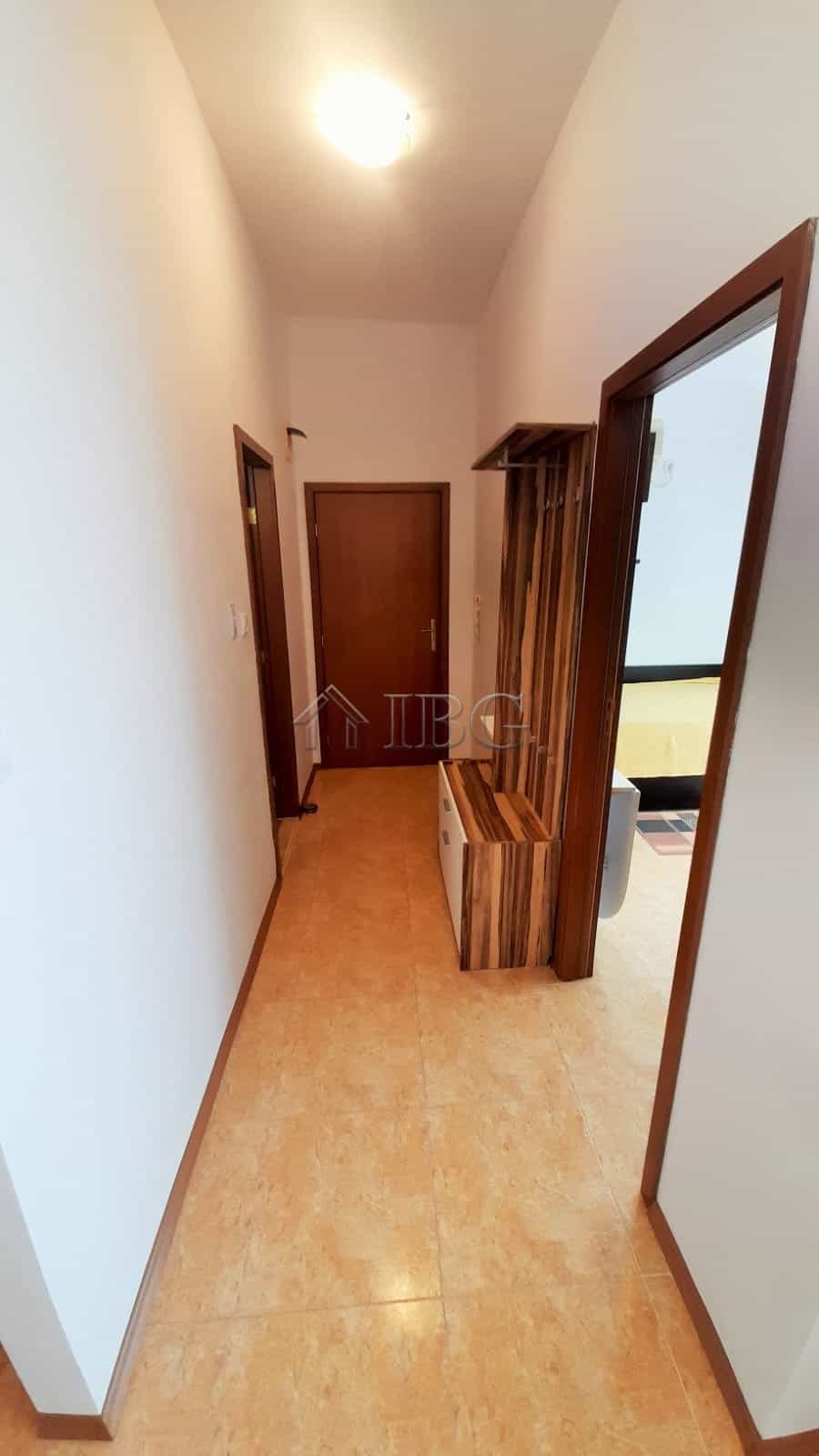 Bright hallway in a modern 1-bedroom apartment with wooden accents and a cozy atmosphere.