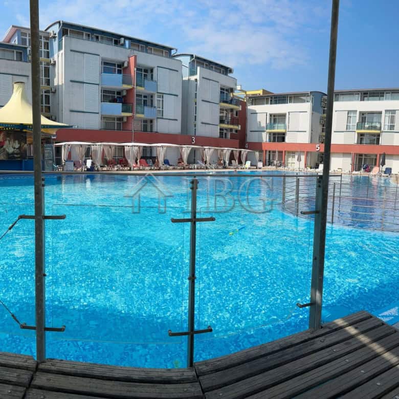 Pool view with surrounding modern apartments in Sunny Beach, Cacao Beach.
