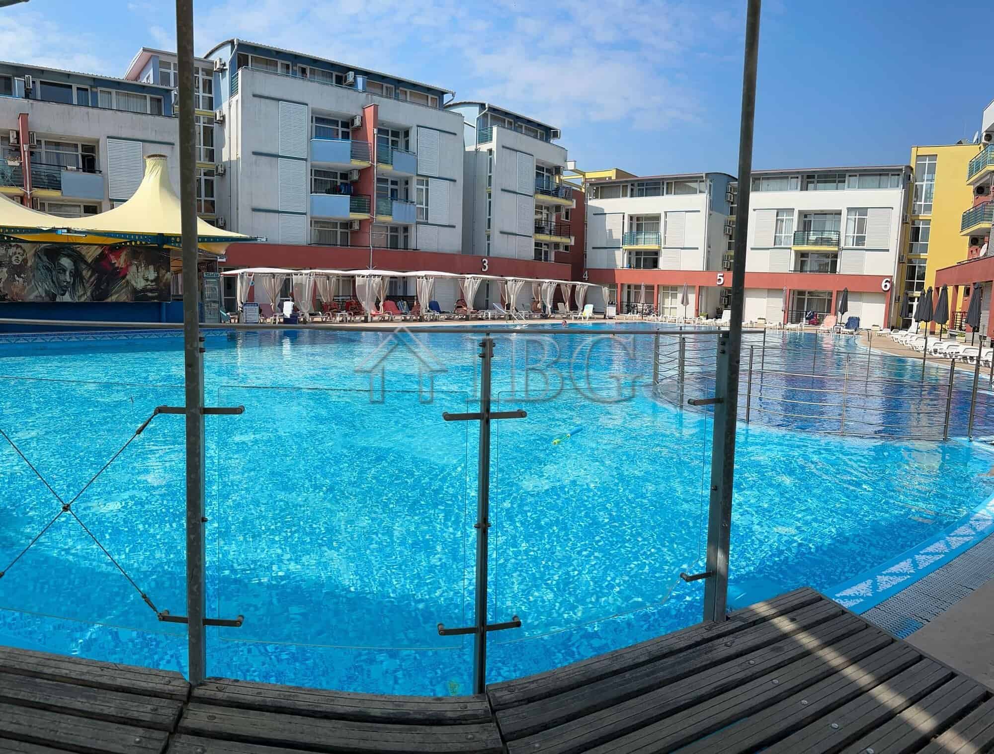 Pool view with surrounding modern apartments in Sunny Beach, Cacao Beach.