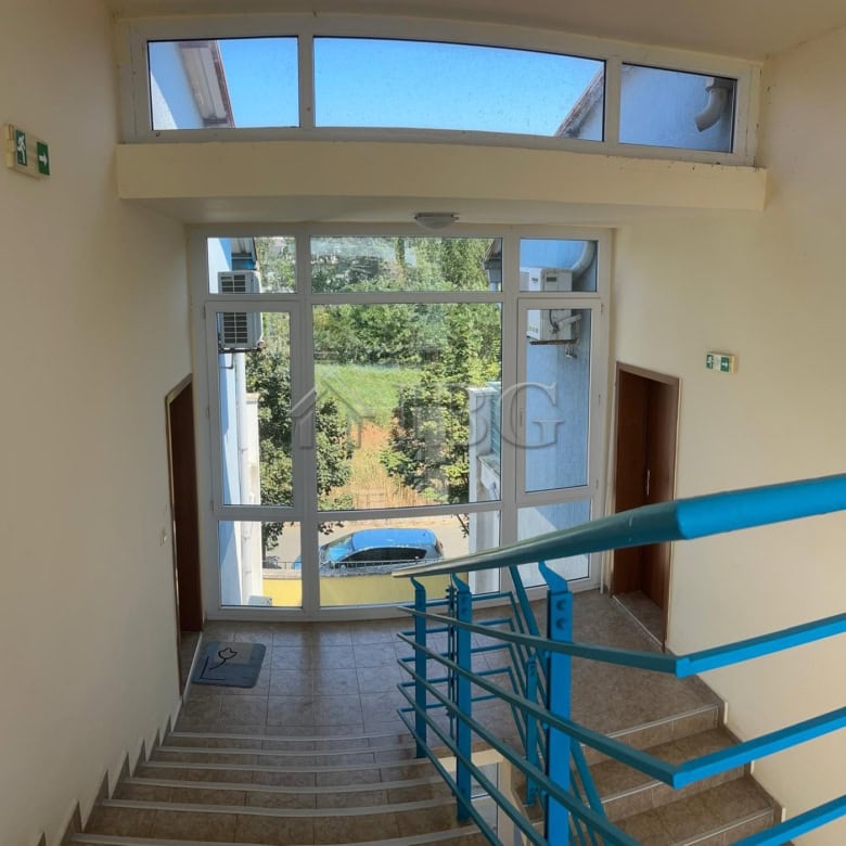 Bright apartment entrance with large glass door and staircase view in Sunny Beach, Cacao Beach area.