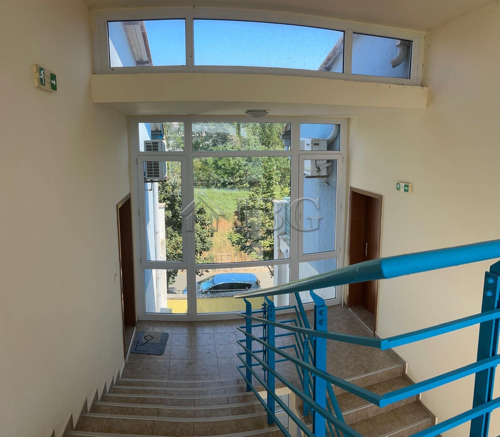 Bright apartment entrance with large glass door and staircase view in Sunny Beach, Cacao Beach area.