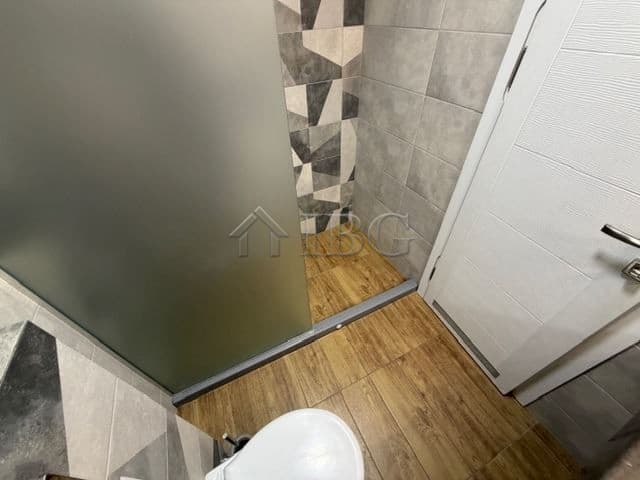 Bright bathroom featuring contemporary tiles and wooden flooring in a luxury Sarafovo apartment.
