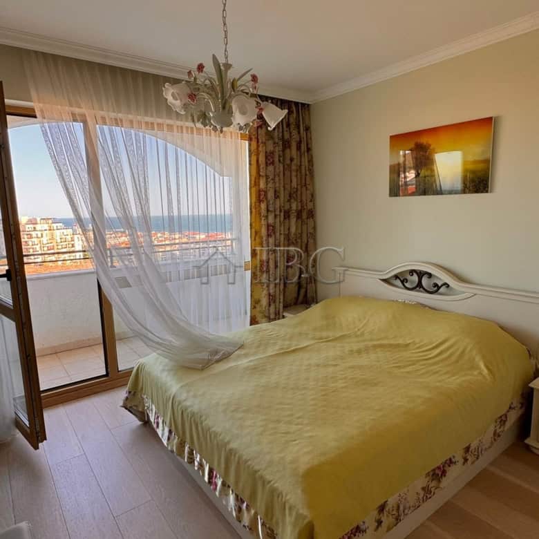 Bright bedroom with large window overlooking the sea and balcony in Sveti Vlas.