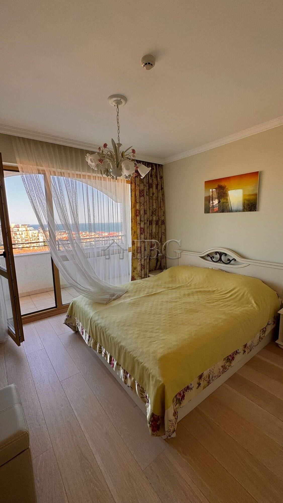 Bright bedroom with large window overlooking the sea and balcony in Sveti Vlas.