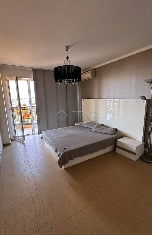 Spacious bedroom with sea and pool views, modern decor, and balcony access in Royal Palm Sveti Vlas.