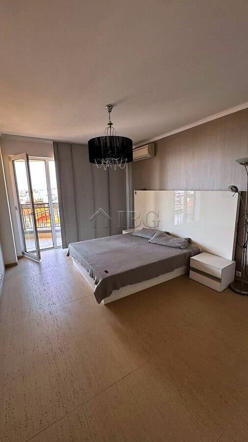 Spacious bedroom with sea and pool views, modern decor, and balcony access in Royal Palm Sveti Vlas.