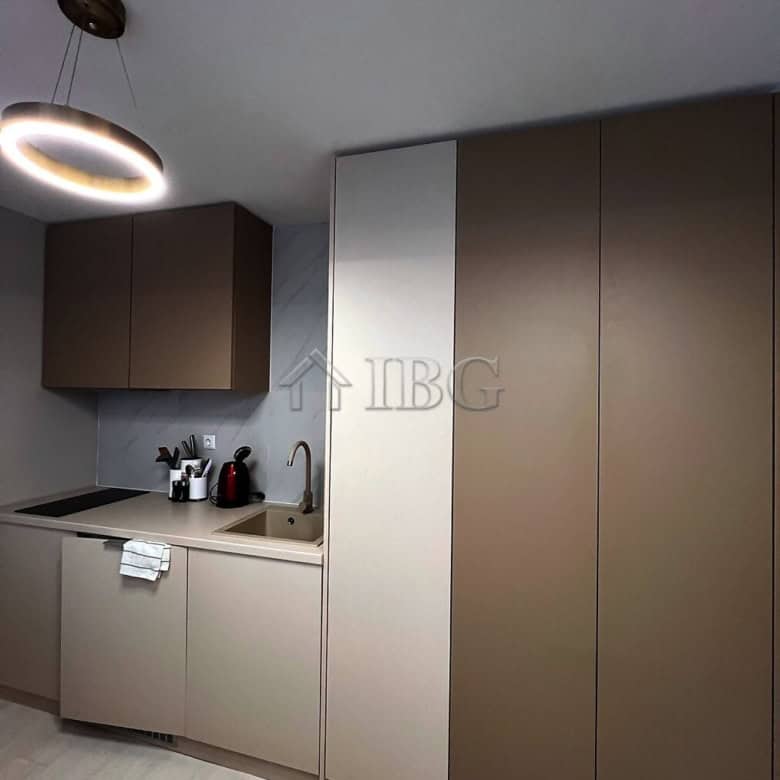 Furnished studio kitchen with modern cabinets and lighting in J’adore Secret Garden, Sunny Beach.