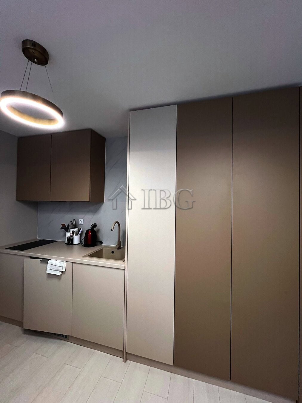 Furnished studio kitchen with modern cabinets and lighting in J’adore Secret Garden, Sunny Beach.