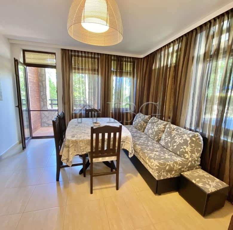 Bright living room with large windows and balcony access.