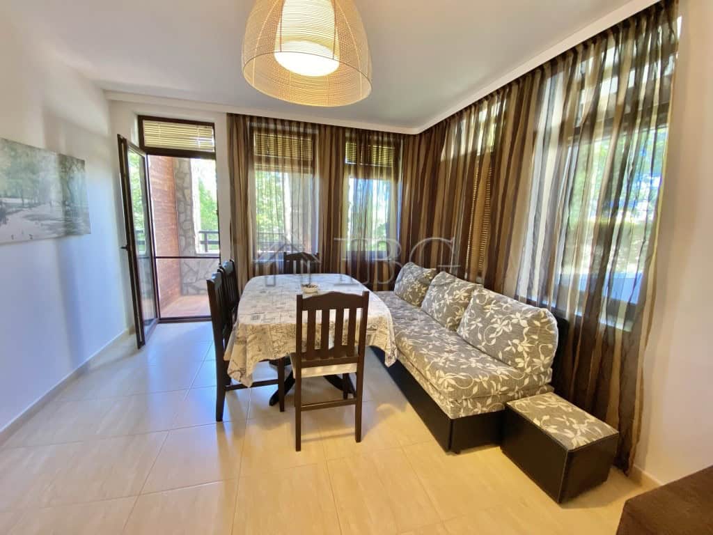Bright living room with large windows and balcony access.