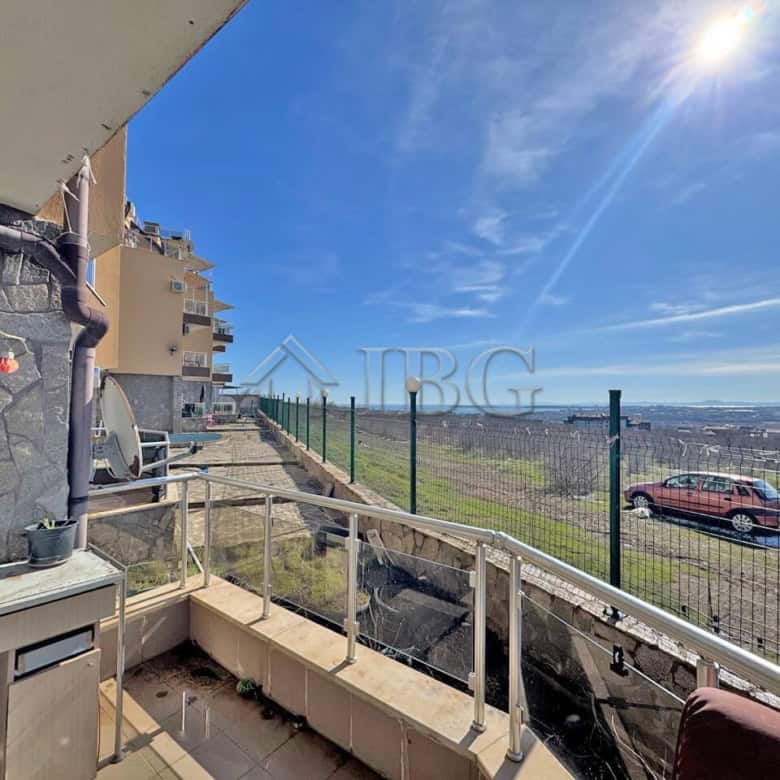Balcony with sea view in Kosharitsa, Bulgaria, showing a sunny day and distant ocean horizon.