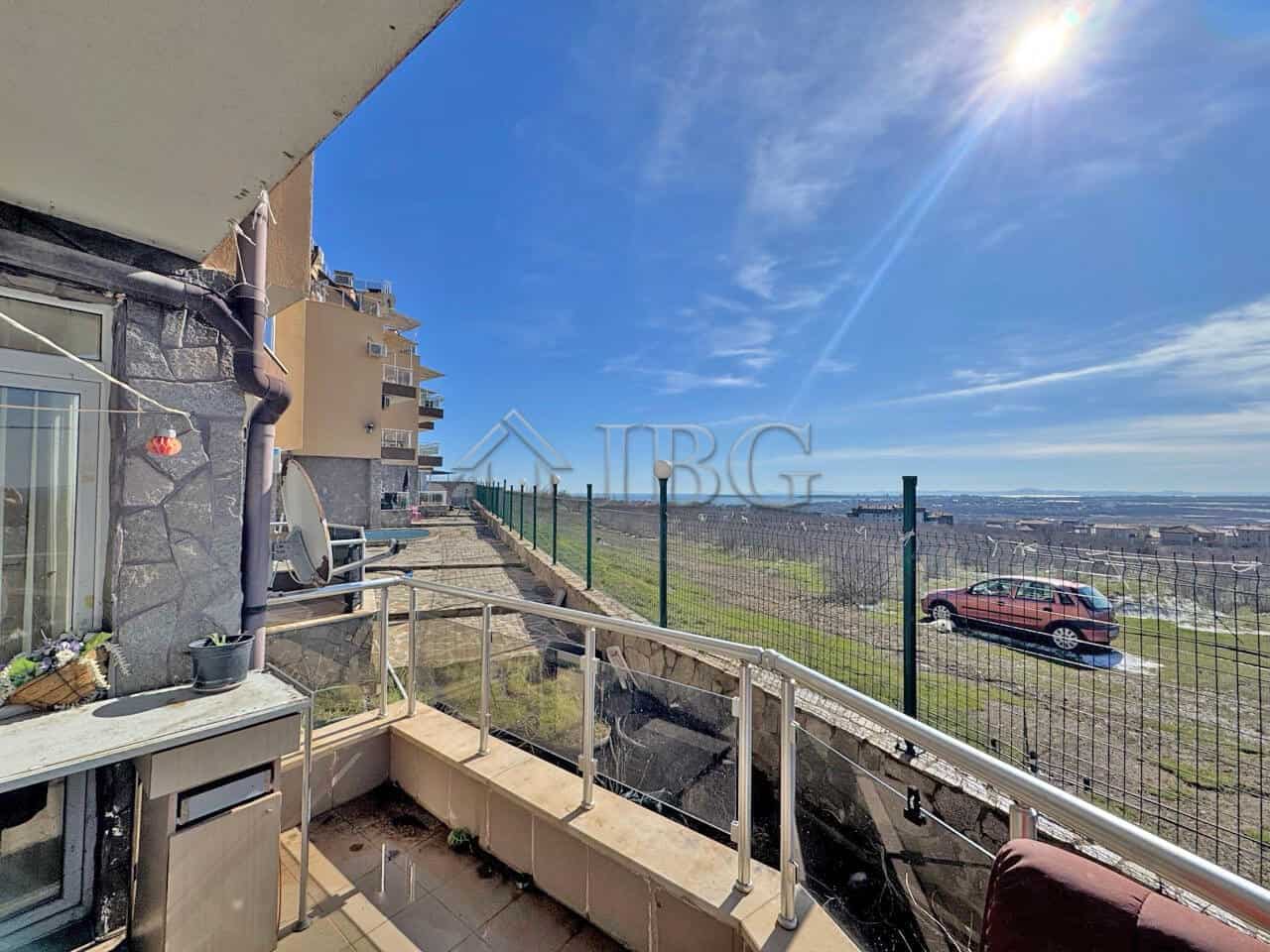 Balcony with sea view in Kosharitsa, Bulgaria, showing a sunny day and distant ocean horizon.