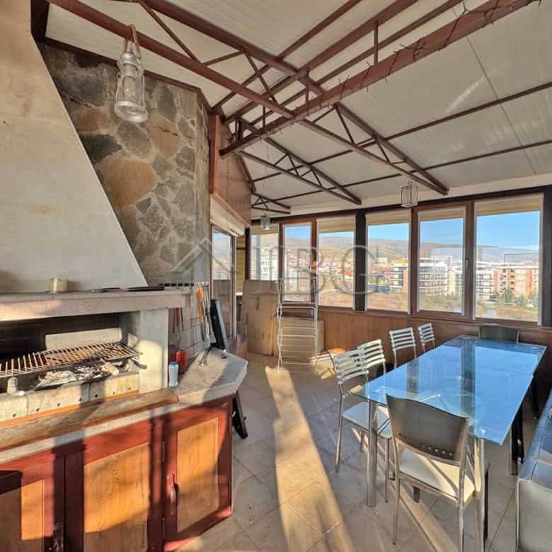 Bright outdoor terrace with seating and large glass windows in Sveti Vlas apartment.