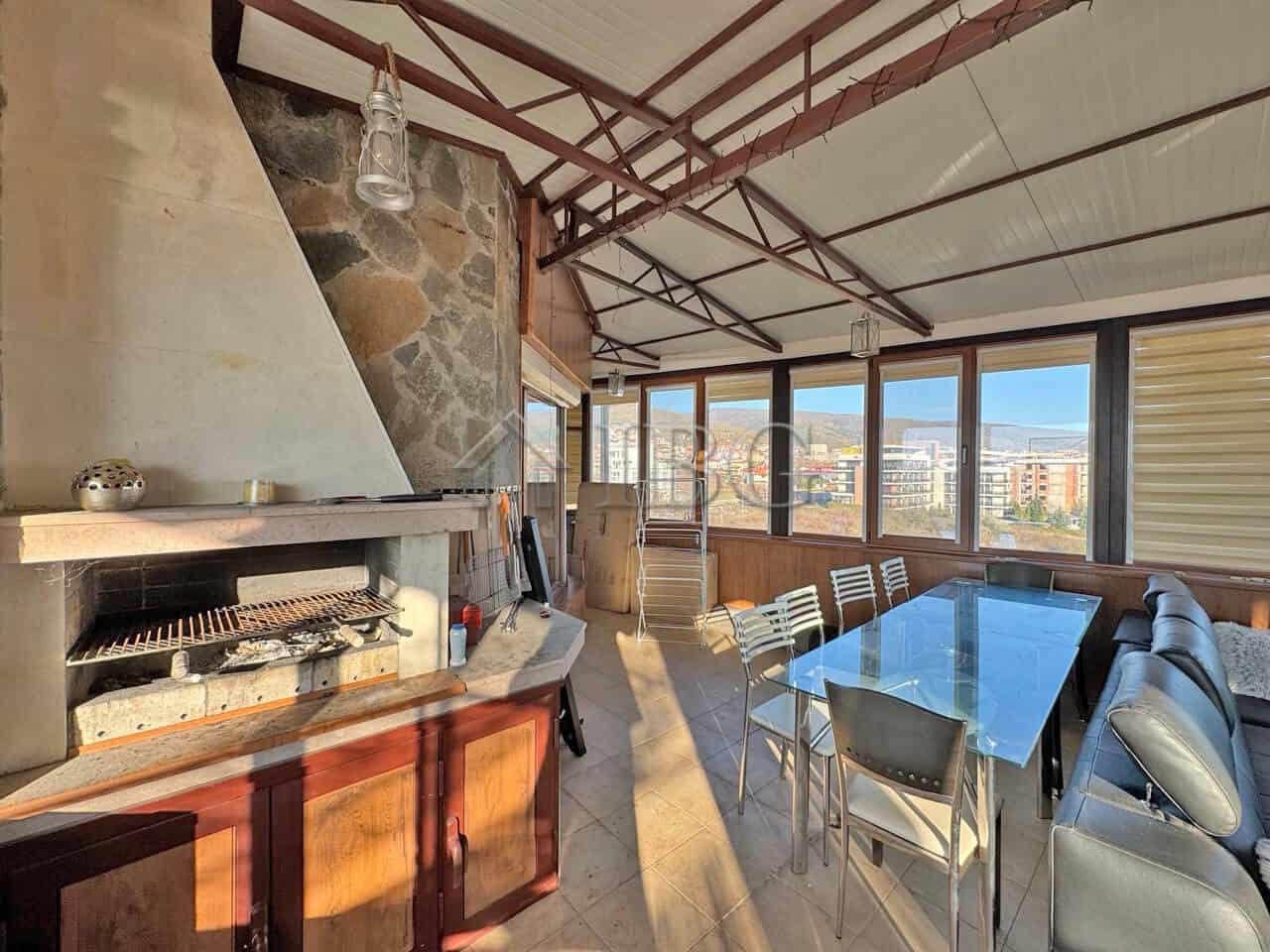 Bright outdoor terrace with seating and large glass windows in Sveti Vlas apartment.