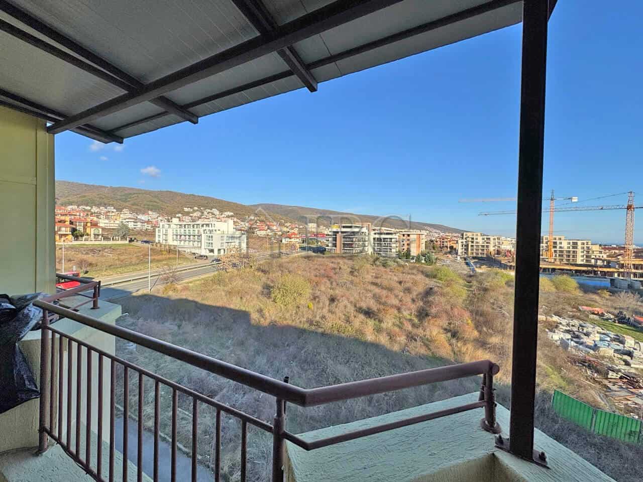 Bright balcony view of Sveti Vlas with city and mountain scenery.
