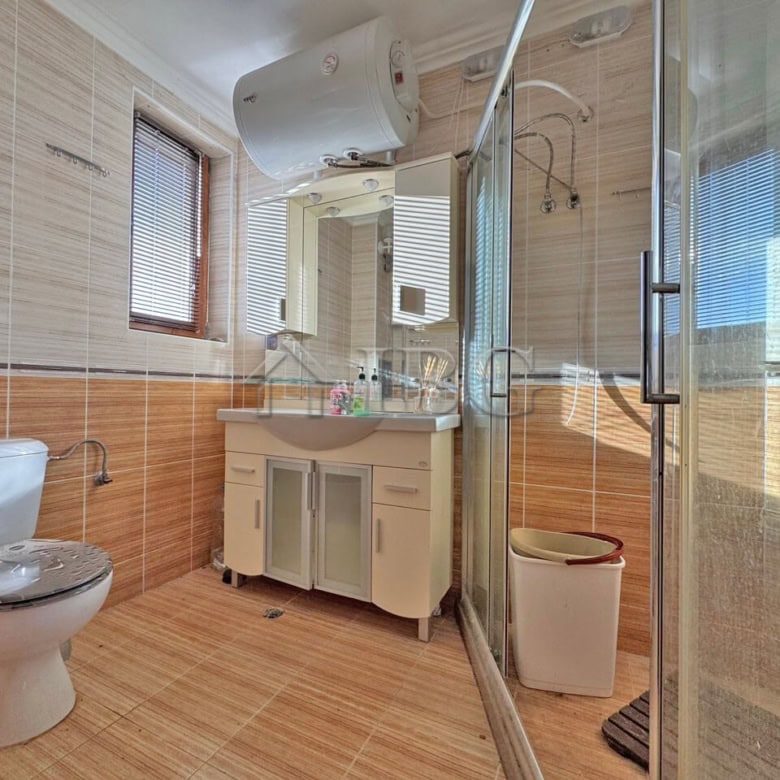 Bright bathroom with modern fixtures and large window in Sveti Vlas apartment.