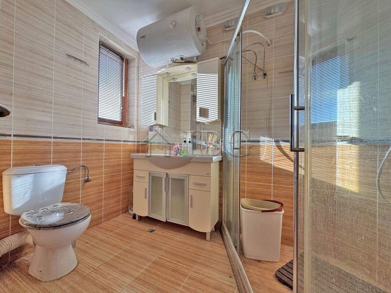 Bright bathroom with modern fixtures and large window in Sveti Vlas apartment.