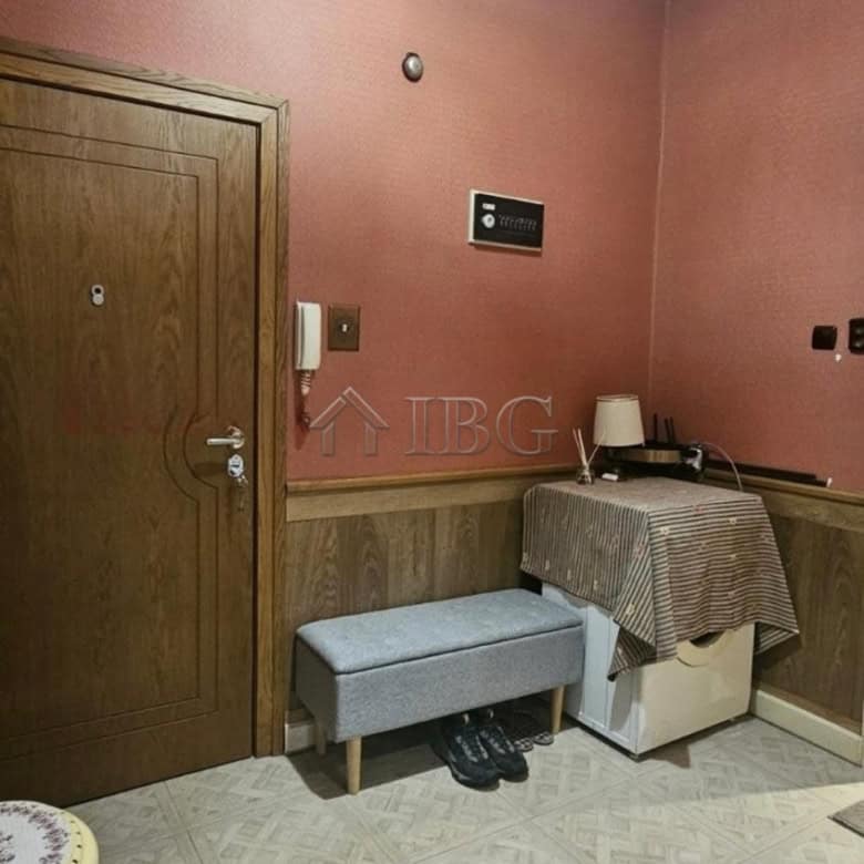 Interior view of a small apartment in Ruse with pink walls and basic furnishings.