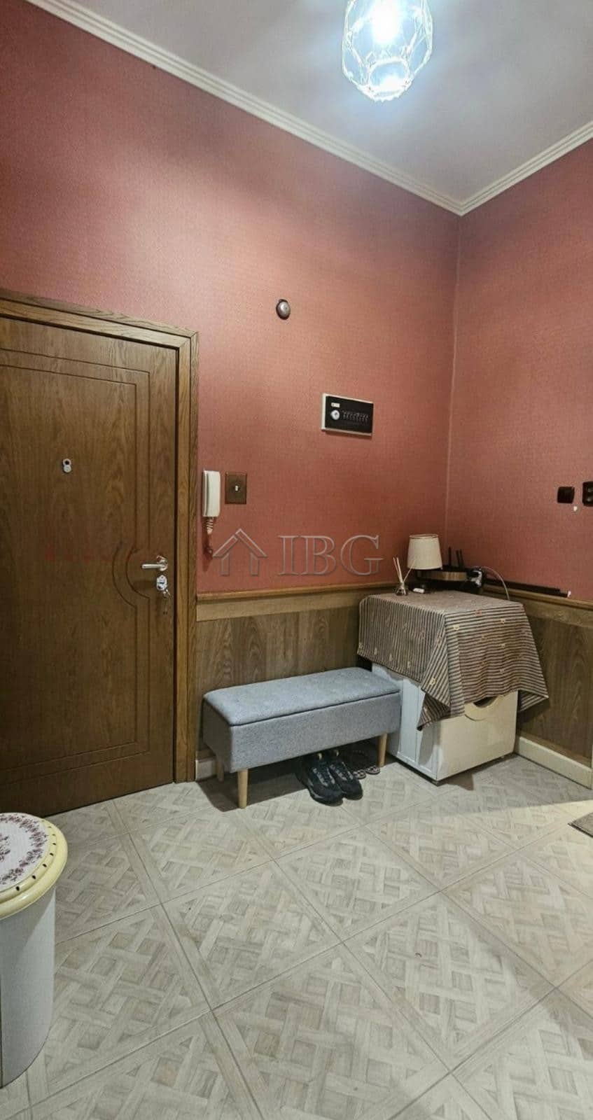 Interior view of a small apartment in Ruse with pink walls and basic furnishings.