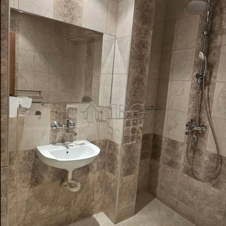 Bright bathroom with modern fixtures in a central Ruse apartment.