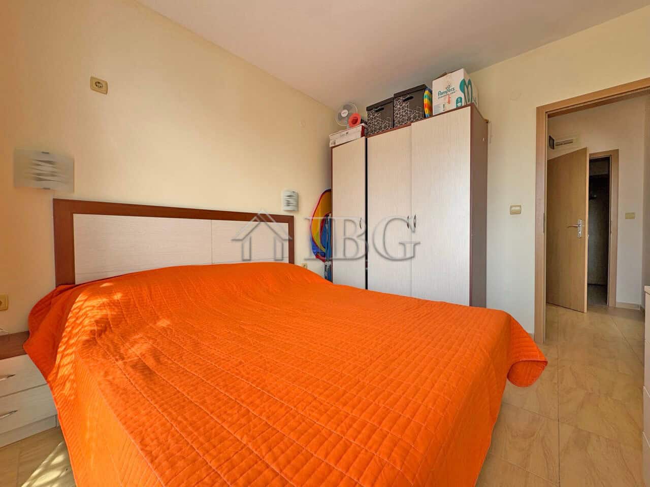 Bright bedroom with orange bedding in Aqua Dreams apartment Sveti Vlas.