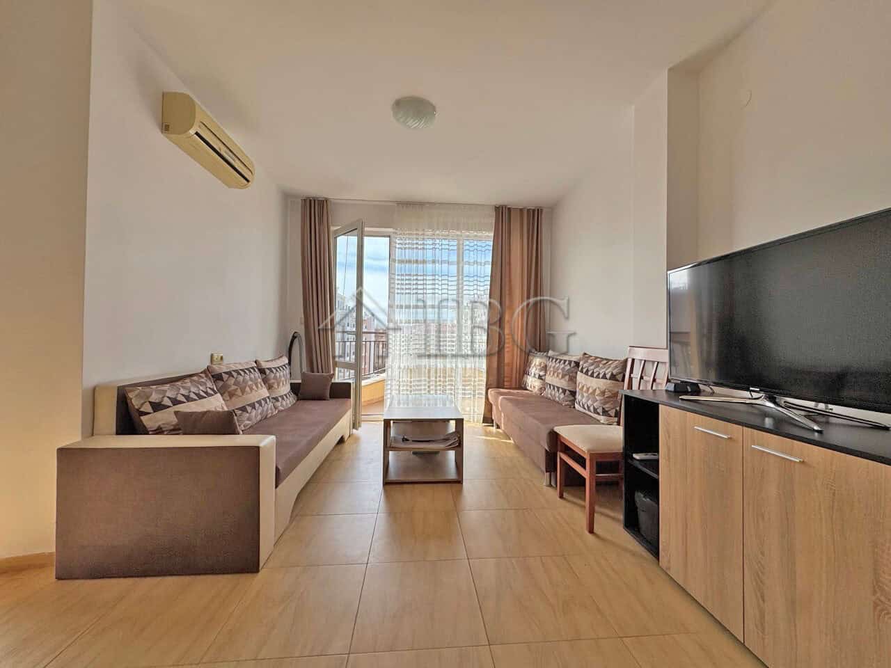 Spacious living room in Aqua Dreams apartment with modern furniture and balcony views in Sveti Vlas.