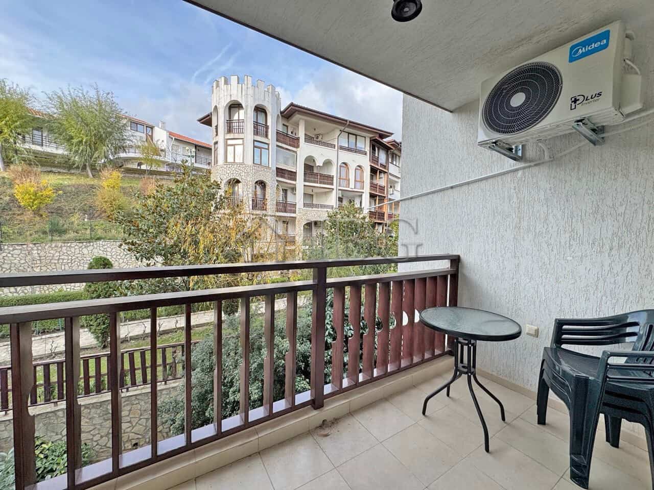 Bright balcony view of residential buildings and greenery in Sveti Vlas.