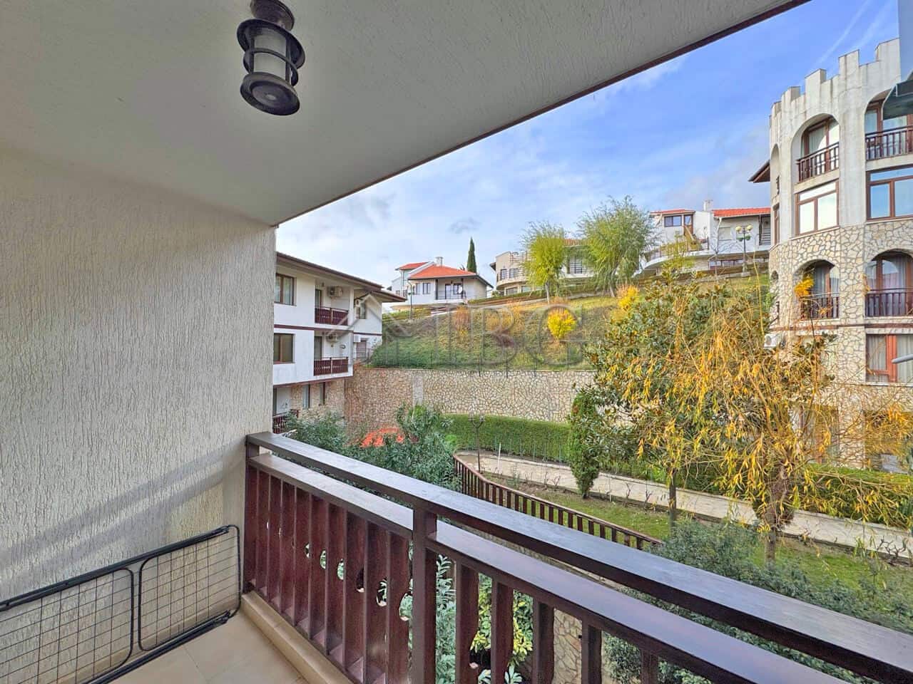 Bright balcony view of the garden and surrounding buildings in Sveti Vlas.