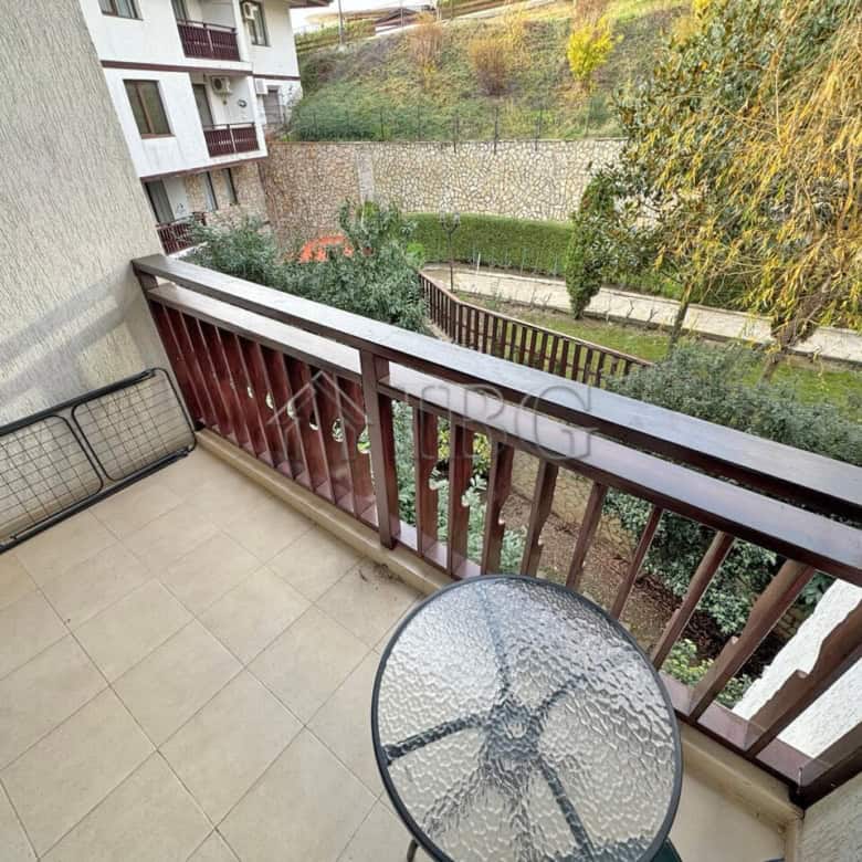 Balcony view of lush greenery and neighboring buildings in Sveti Vlas.