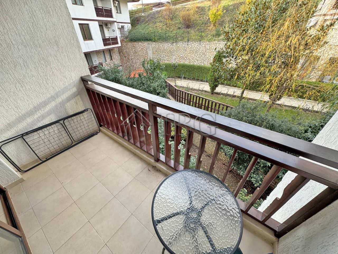 Balcony view of lush greenery and neighboring buildings in Sveti Vlas.