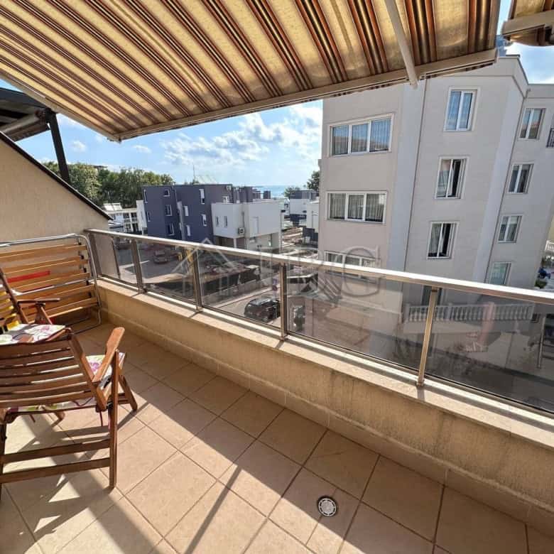 Comfortable balcony with city views in Ravda apartment.