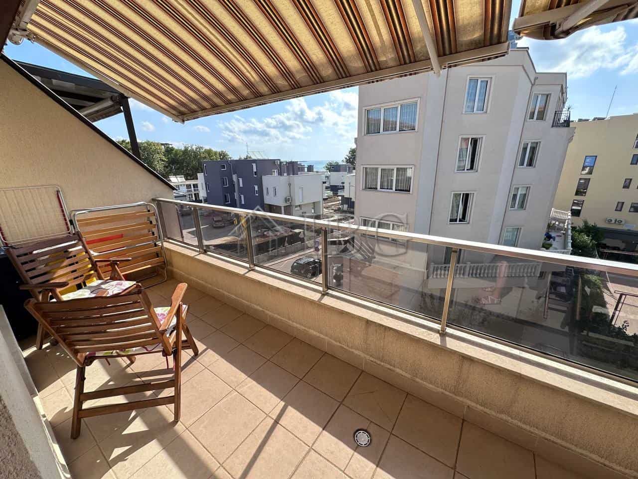 Comfortable balcony with city views in Ravda apartment.