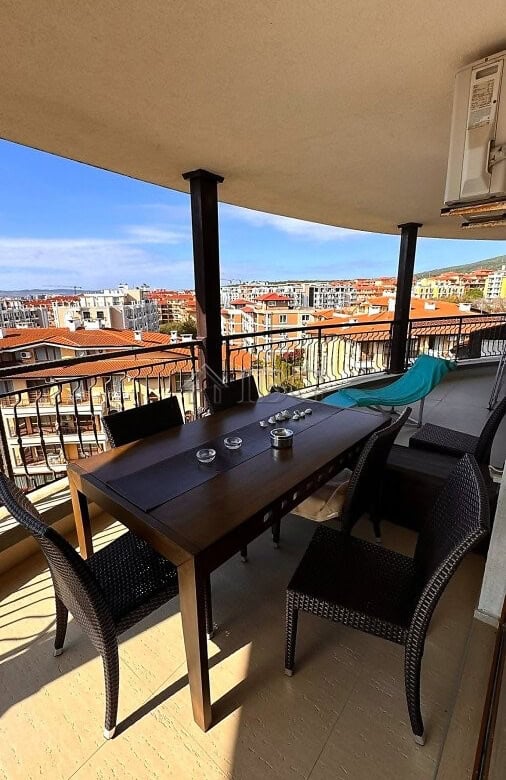 Balcony with sea and pool views in Sveti Vlas, featuring outdoor dining furniture and relaxing seati.