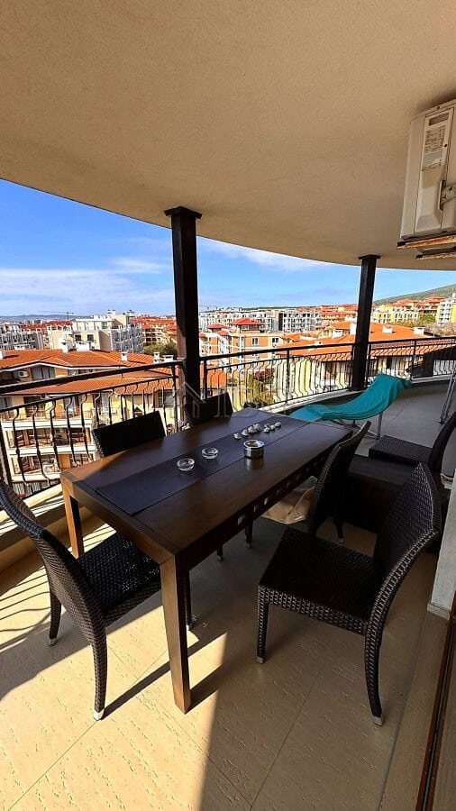 Balcony with sea and pool views in Sveti Vlas, featuring outdoor dining furniture and relaxing seati.