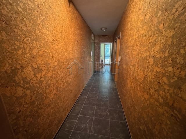 Spacious hallway of a 1-bedroom apartment in Burgas' Vazrazhdane district, featuring warm textured w.