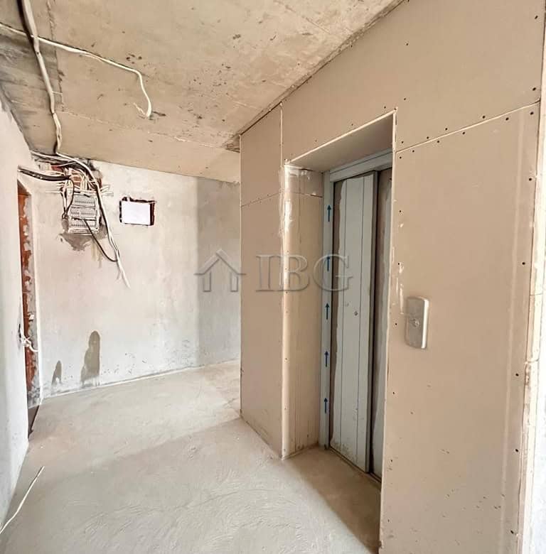 Elevator door in a new apartment with unfinished walls and wiring.
