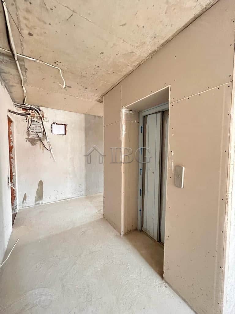 Elevator door in a new apartment with unfinished walls and wiring.