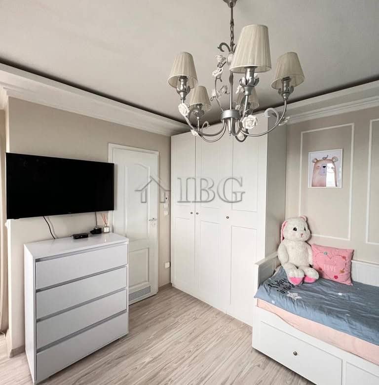Charming bedroom featuring a white wardrobe, bed, and soft decor in a seaside property.